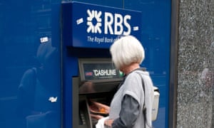 retired woman using a cash dispenser at a Royal Bank of Scotland ATM in Central London