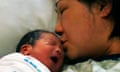 A baby is kissed by their mother shortly after being born