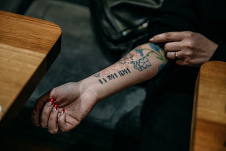 Valeria Subotina pulls up her sleeve to reveal a tattoo.
