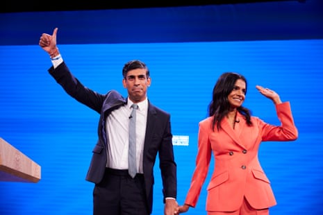 Rishi Sunak exits the stage with his wife, Akshata Murty, after making his conference speech.