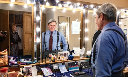 Broderick looks in the mirror in his dressing room, whilst Davina Elliiot, Principal Dresser, looks on