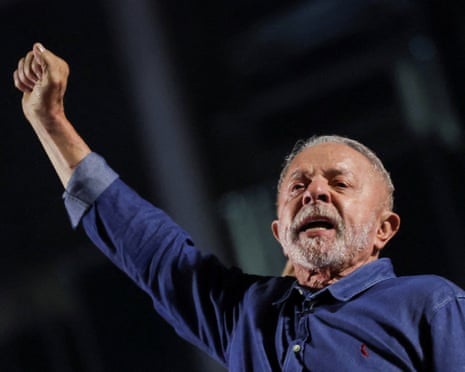 Lula da Silva raises his fist and shouts, addressing supporters after his election win.