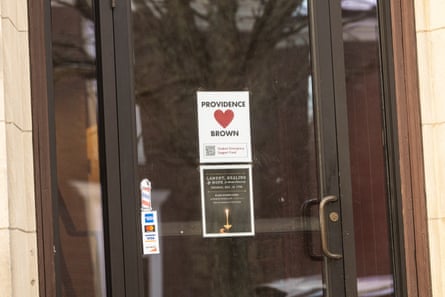 Sign on plate glass door says Providence / Brown, with a red heart and a QR code.
