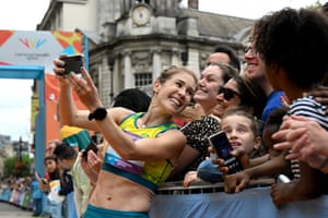 Australia’s Jessica Stenson poses for photos with spectators after winning gold in the women’s marathon