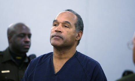 Man in courtroom wearing blue jail uniform