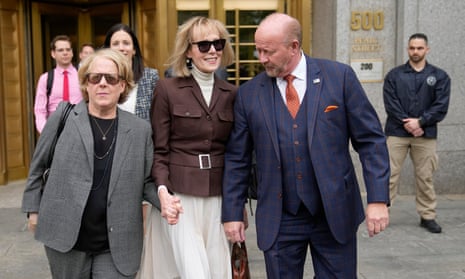 E Jean Carroll, center, walks out of Manhattan federal court in New York on 9 May. 