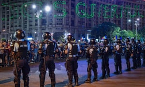 A laser message spells out “Jos Guvernul” (down with the government) in front of the government’s headquarters in Bucharest 5437.jpg?w=300&q=55&auto=format&usm=12&f