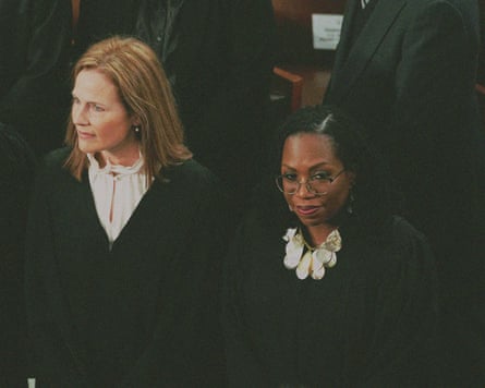 Two supreme court justices stand in a crowd