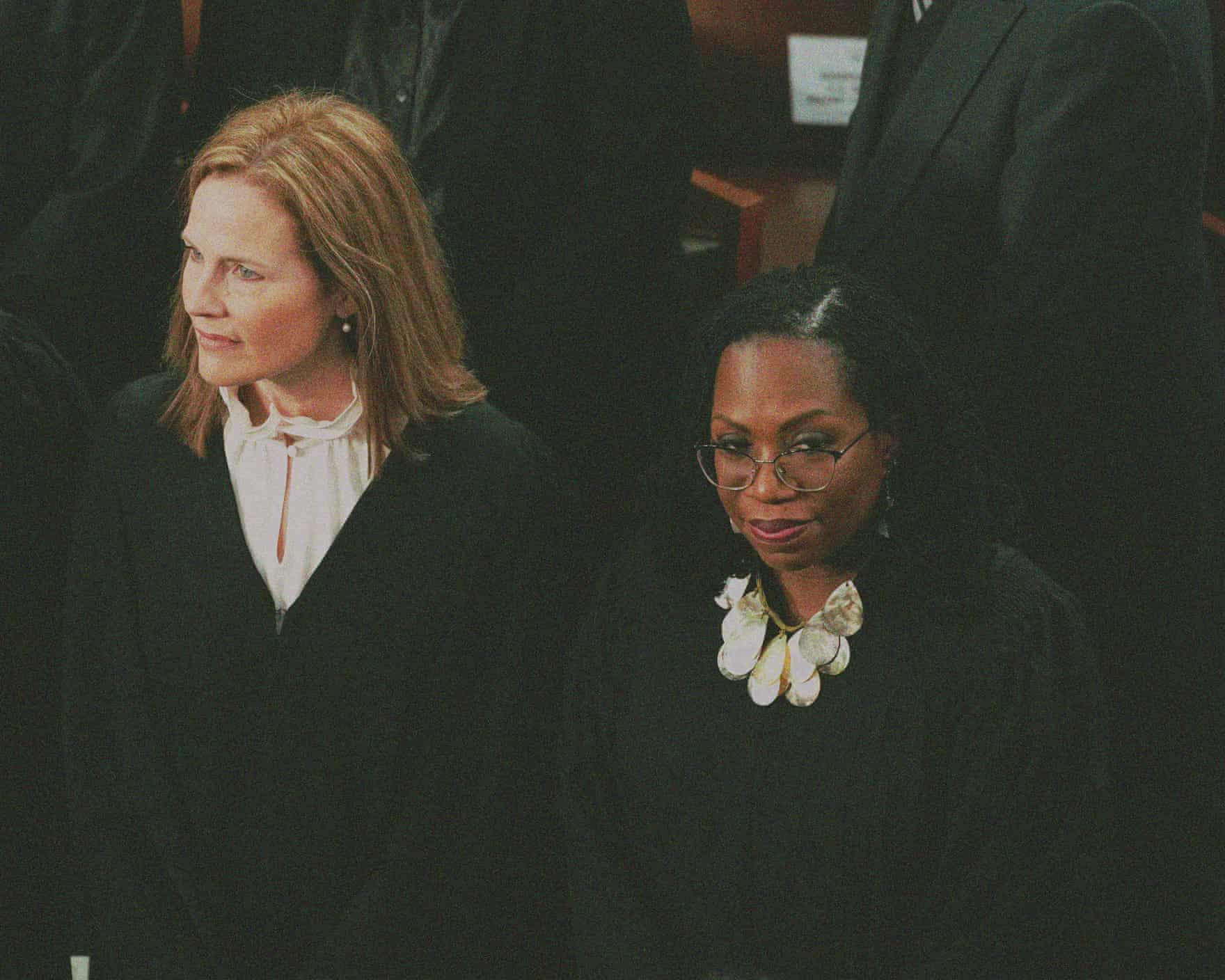 Two supreme court justices stand in a crowd