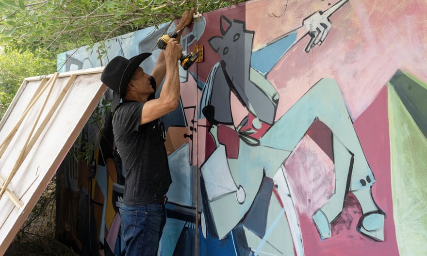 Dallas based artist Roberto Marquez sets up his paintings dedicated to migrants.