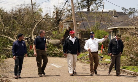Donald Trump tours damage from Hurricane Laura on Saturday in Lake Charles, Louisiana, with Governor John Bel Edwards, second from right. At far left is the homeland security secretary, Chad Wolf.