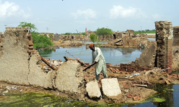 Man digs destroyed home in Jafarabad.