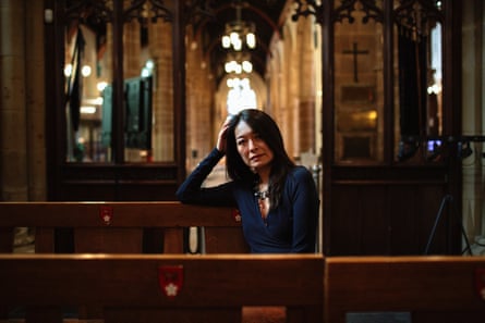 Janis Chen, who has terminal lung cancer, sitting in a pew, head resting on her hand, in Leicester cathedral, Feb 2026