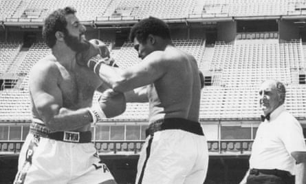 Ali throws a punch amid his eight-round exhibition against Lyle Alzado at Mile High Stadium