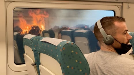 Spain heatwave: passengers stuck on train surrounded by wildfires – video