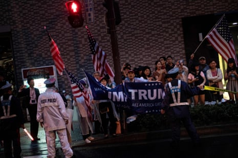 JAPAN-G20-SUMMITPeople watch as US President Donald Trump’s motorcade travels past in Osaka on June 27, 2019. (Photo by Brendan Smialowski / AFP)BRENDAN SMIALOWSKI/AFP/Getty Images