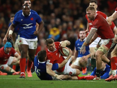 Dan Biggar beats Anthony Bouthier of France to score his side’s second try.