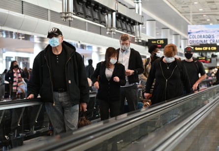 Travelers at Denver international airport on 30 November wear face masks as concern grows over the Omicron variant.