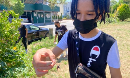 Joshua Nunez, 13, shows off the body of a spotted lanternfly.