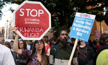 Protesters hold banners that read: ‘Stop offshoring deportations, Rwanda flight’