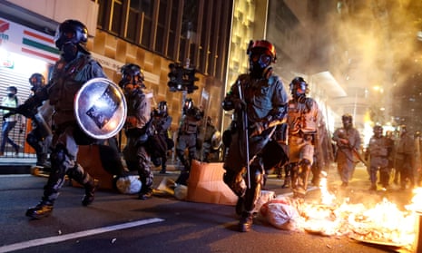 Police passed a burning barricade to break up anti-government protesters in Hong Kong on November 2, 2019.