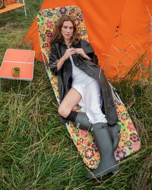 Alexa Chung wearing a barbour jacket on a sun lounger