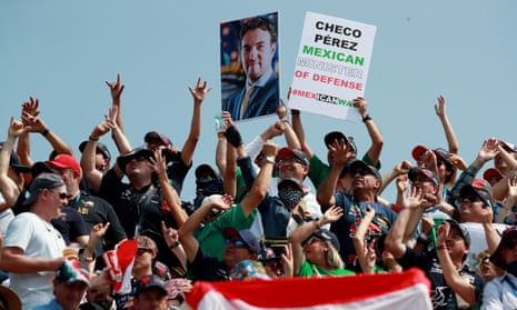 aFns hold up an image of Red Bull's Sergio Perez before the race
