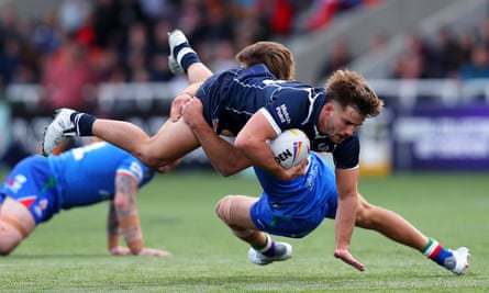 Scotland’s Calum Gahan is tackled by Luke Polselli during the game at Kingston Park.