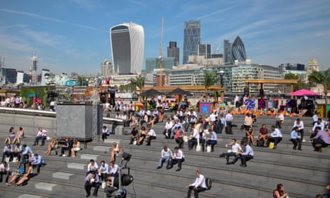 Workers enjoy the lunchtime sunshine in City of London
