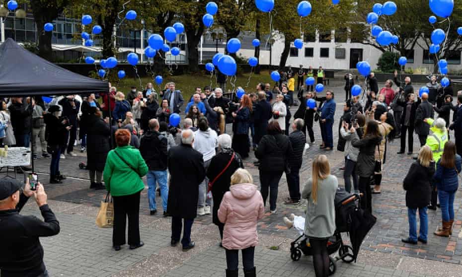 People release blue balloons during a vigil for David Amess at the Civic Centre in Southend-on-Sea