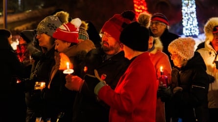 Edmontonians hold candles during the vigil to show support for the families and friends of those who were victimized by ICE agents