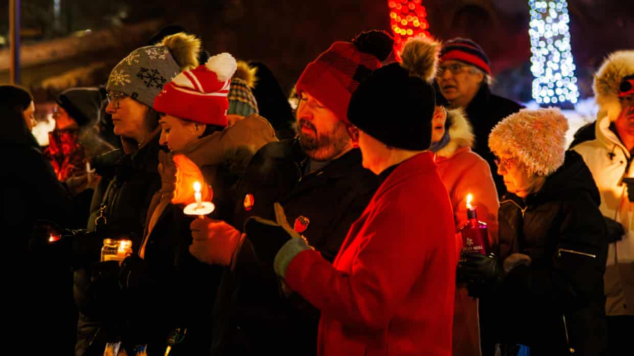 Edmontonians hold candles during the vigil to show support for the families and friends of those who were victimized by ICE agents
