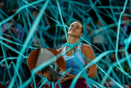 Aryna Sabalenka holds the winner's trophy after victory in Madrid