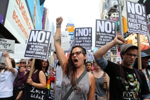 Protesters chant anti-white-nationalism slogans in Times Square, the day after the attack on counter-protesters in Charlottesville