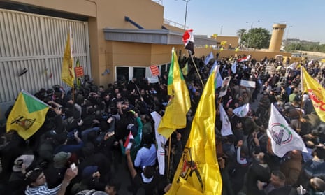 Protesters and militia fighters demonstrating against the airstrikes outside the main gate of the US embassy in Baghdad on Tuesday.