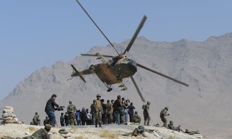 An Afghan air force Mi-17 helicopter flies past commandos during a military exercise on the outskirts of Kabul in October 2017