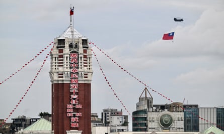 A helicopter carrying Taiwan’s flag flies past the presidential office building during Lai Ching-te’s inauguration ceremonies in Taipei