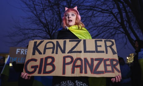 A protester hold up a placard reading: ‘Chancellor give tanks’, in reference to Olaf Scholz.