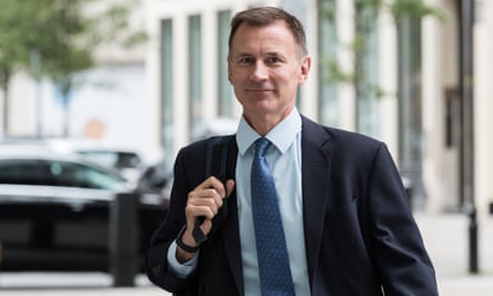 Jeremy Hunt carrying a bag over his shoulder