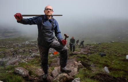 Team member Kieran Fogarty, The NTS Mountain Path Team at work repairing a path up Mullach an Rathain summit, on Liathach in Torridon