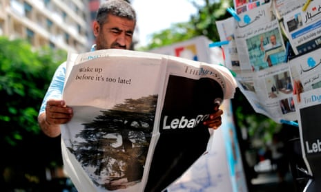 A man reading the Lebanese English-language newspaper the Daily Star in August 2019