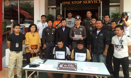 Hua Hin police stand behind two suspects arrested following the assault on the British couple and their son.