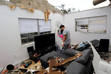 Jose Pico sifts through the wreckage of his apartment which was destroyed after a tornado, spawned from Tropical Storm Cristobal, passed through Orlando, Florida.