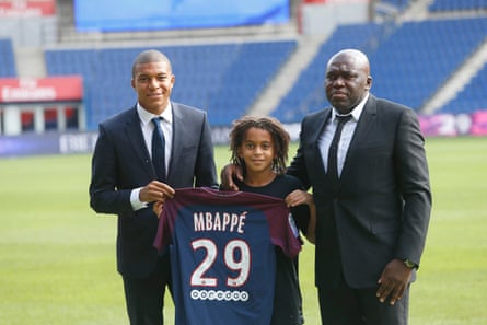 Kylian Mbappé with his father, Wilfrid, and brother, Ethan, after signing for Paris Saint-Germain.