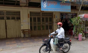 A man on a motorbike past the offices of Ambrosia Labs in Phnom Penh.