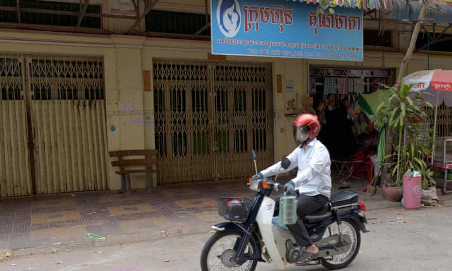 A man on a motorbike past the offices of Ambrosia Labs in Phnom Penh. 