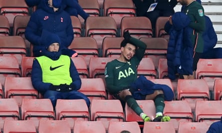 Dele Alli watches the match from the stands after being substituted.