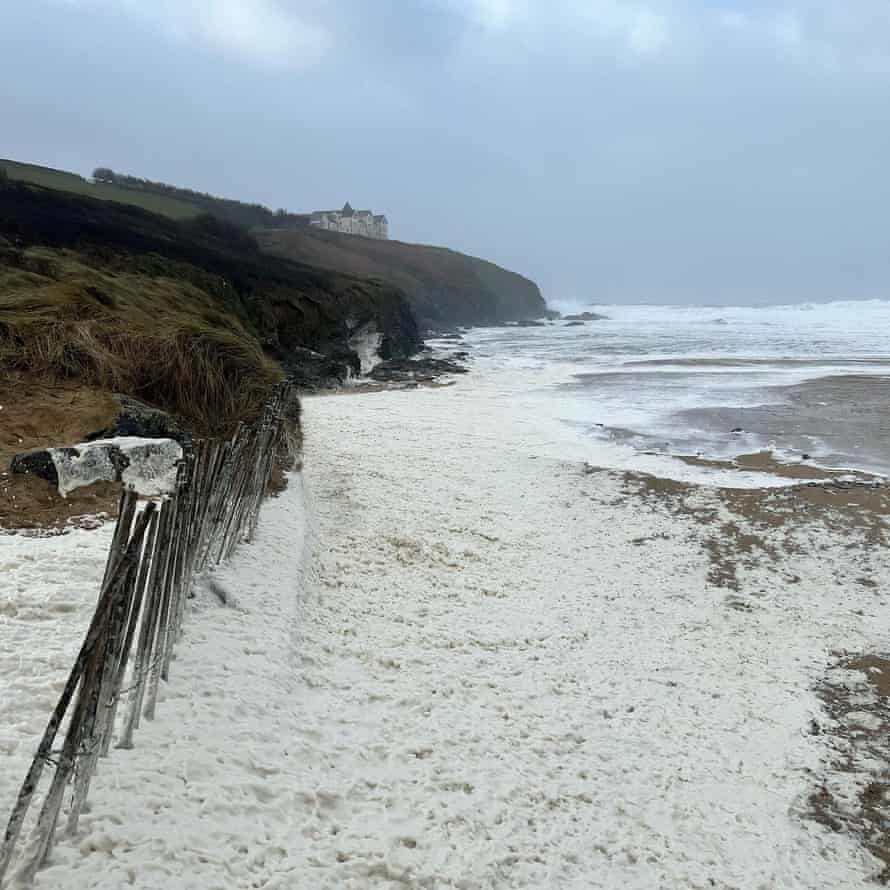 The thick sea foam along Poldhu Beach.