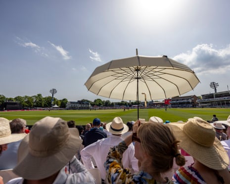 An spectator raises a parasol from the stands to shield themselves from the sun during the Vitality IT20 match at The Spitfire Ground, Canterbury, on Saturday