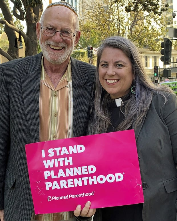 Rabbi and minister with Planned Parenthood sign